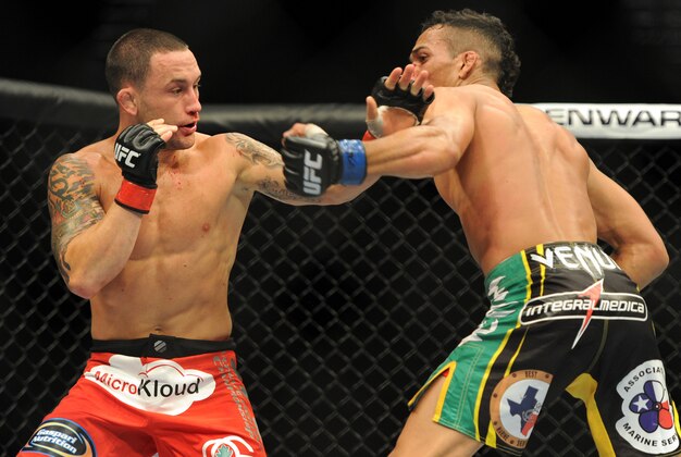 Jul 6, 2013; Las Vegas, NV, USA;  Frankie Edgar (red gloves) and Charles Oliveira (blue gloves) during their Featherweight Bout at the MGM Grand Garden Arena. Edgar won. Mandatory Credit: Jayne Kamin-Oncea-USA TODAY Sports