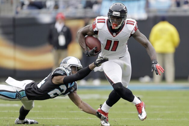 Atlanta Falcons' Julio Jones (11) looks up field as he runs away from Carolina Panthers' Josh Norman (24) during the first half of an NFL football game in Charlotte, N.C., Sunday, Nov. 16, 2014. The Falcons won 19-17. (AP Photo/Bob Leverone)