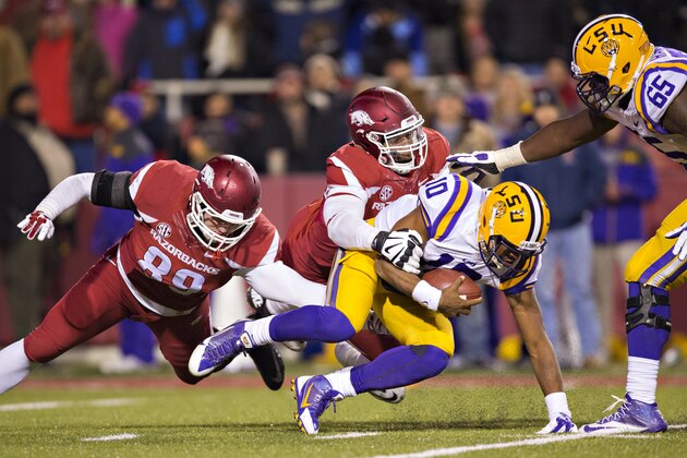 FAYETTEVILLE, AR - NOVEMBER 15:  Anthony Jennings #10 of the LSU is sacked by Deatrich Wise Jr. #43 of the Arkansas Razorbacks at Razorback Stadium on November 15, 2014 in Fayetteville, Arkansas.  The Razorbacks defeated the Tigers 17-0.  (Photo by Wesley Hitt/Getty Images)