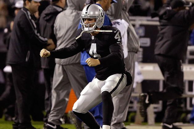 OAKLAND, CA - NOVEMBER 20:  Derek Carr #4 of the Oakland Raiders celebates after Latavius Murray #28 scored a touchdown in the second quarter of the game agains the Kansas City Chiefs at O.co Coliseum on November 20, 2014 in Oakland, California.  (Photo by Ezra Shaw/Getty Images)