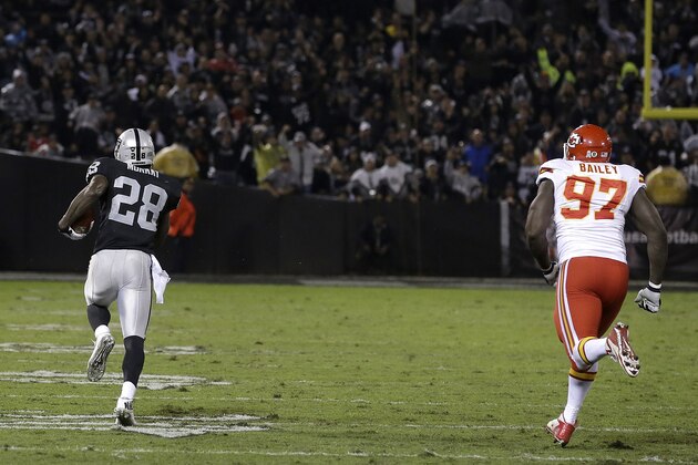 Oakland Raiders running back Latavius Murray (28) runs toward the end zone past Kansas City Chiefs defensive end Allen Bailey (97) to score on a 90-yard touchdown run during the second quarter of an NFL football game in Oakland, Calif., Thursday, Nov. 20, 2014. (AP Photo/Ben Margot)