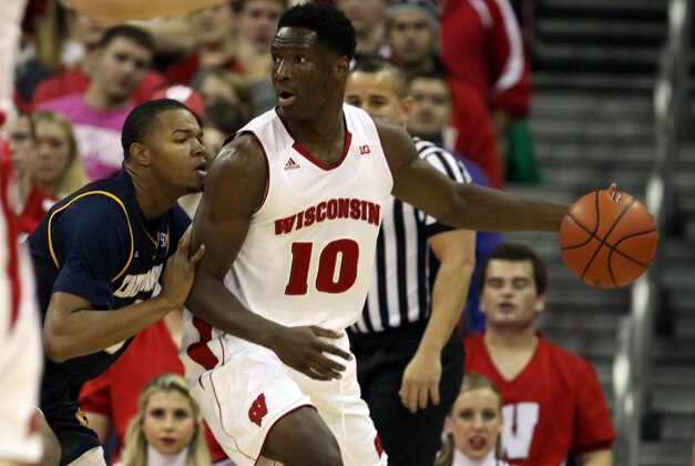 Nov 16, 2014; Madison, WI, USA; Wisconsin Badgers forward Nigel Hayes (10) attempts to move the ball past Chattanooga Mocs forward Chuck Ester (0) during the first half at the Kohl Center. Mandatory Credit: Mary Langenfeld-USA TODAY Sports