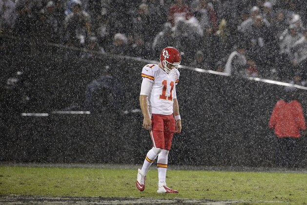 Rain falls as Kansas City Chiefs quarterback Alex Smith (11) walks on the field during the second quarter of an NFL football game against the Oakland Raiders in Oakland, Calif., Thursday, Nov. 20, 2014. (AP Photo/Marcio Jose Sanchez)