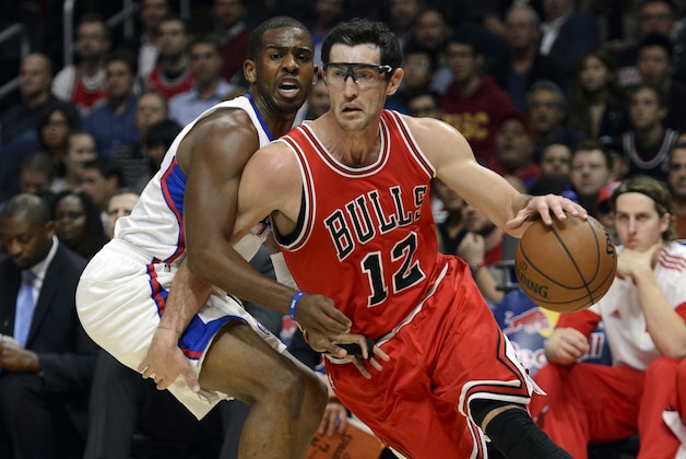 Nov 17, 2014; Los Angeles, CA, USA; Chicago Bulls guard Kirk Hinrich (12) drives the ball defended by Los Angeles Clippers guard Chris Paul (back) during the first quarter at Staples Center. Mandatory Credit: Kelvin Kuo-USA TODAY Sports