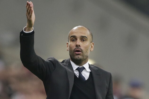 Bayern's head coach Pep Guardiola gestures during the Champions League Group E soccer match between FC Bayern Munich and AS Roma at Allianz Arena in Munich, southern Germany, Wednesday Nov. 5, 2014. (AP Photo/Matthias Schrader)