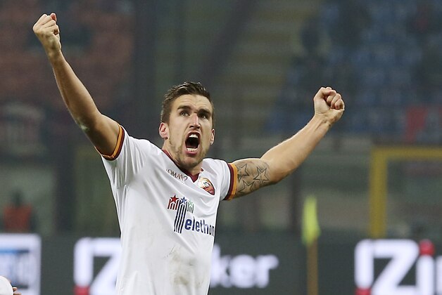AS Roma midfielder Kevin Strootman, of the Netherlands, celebrates after scoring during the Serie A soccer match between AC Milan and Roma at the San Siro stadium in Milan, Italy, Monday, Dec. 16, 2013. (AP Photo/Antonio Calanni)