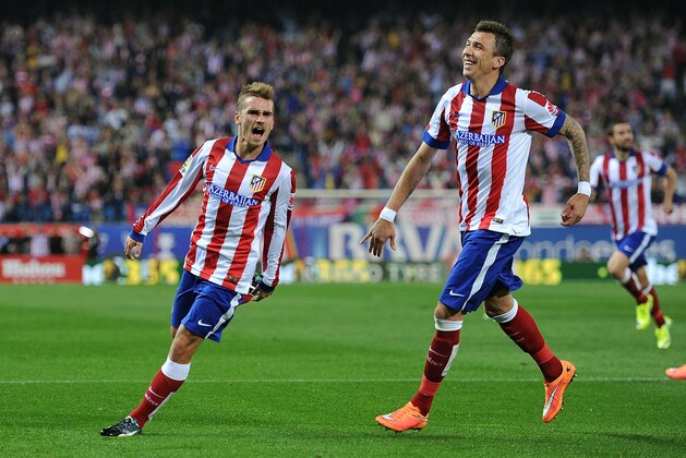 MADRID, SPAIN - NOVEMBER 01:  Antoine Griezmann of Club Atletico de Madrid celebrates with Mario Mandzukic after scoring his team's opening goal during the La Liga match between Club Atletico de Madrid and Cordoba CF at Vicente Calderon Stadium on November 1, 2014 in Madrid, Spain.  (Photo by Denis Doyle/Getty Images)