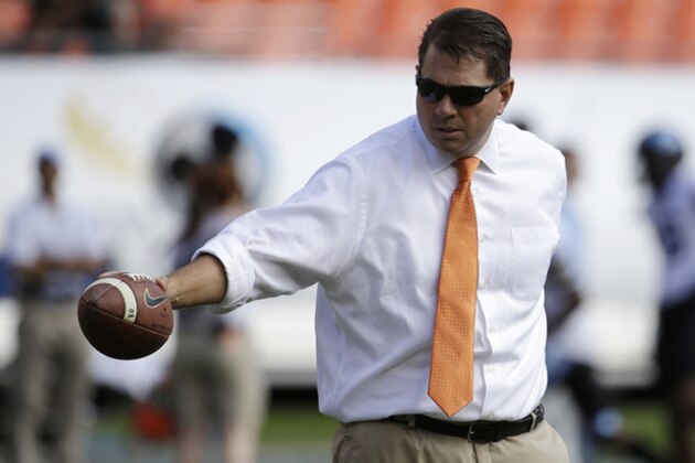 Miami head coach Al Golden hands off the football to an assistant before an NCAA football game against North Carolina, Saturday, Nov. 1, 2014, in Miami Gardens, Fla. (AP Photo/Lynne Sladky)