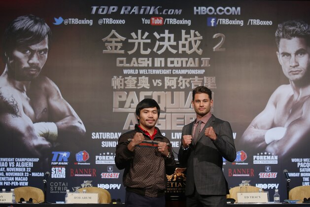 Boxers Manny Pacquiao, left, of the Philippines, and Chris Algieri of the United States, pose for photographers during a news conference in Macau, Monday, Aug. 25, 2014. The pair are scheduled to fight in a WBO welterweight title bout at the Venetian Macao on Nov. 23 in Macau. (AP Photo/Vincent Yu)