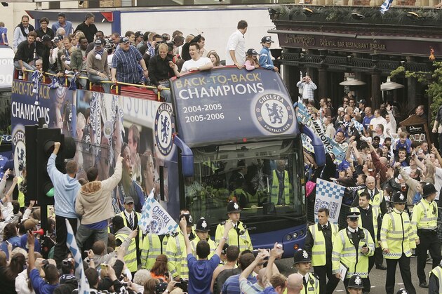 LONDON - MAY 14:  Fans wave to the players as Premierhip Champions Chelsea parade on an open top bus on May 14, 2006 in London. Chelsea became only the second club to win back to back Premiership Titles gaining manager Jose Mourinho his second title in two years. (Photo by Peter Macdiarmid/Getty Images)