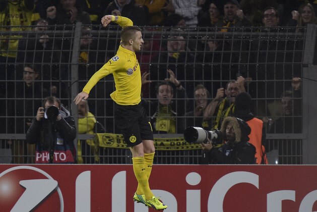 Dortmund's Marco Reus celebrates after scoring the opening goal during the Champions League group D soccer match between Borussia Dortmund and Galatasaray Istanbul in Dortmund, Germany, Tuesday, Nov.4,,2014. (AP Photo/Martin Meissner)