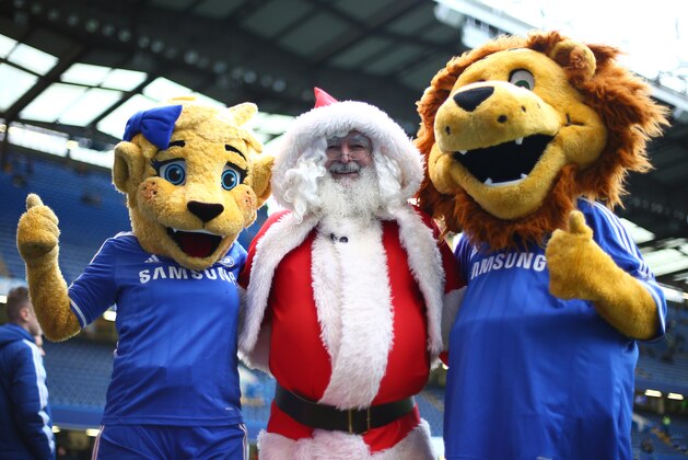 LONDON, ENGLAND - DECEMBER 14: Father Christmas poises with the Chelsea mascots during the Barclays Premier League match between Chelsea and Crystal Palace at Stamford Bridge on December 14, 2013 in London, England. (Photo by Paul Gilham/Getty Images)
