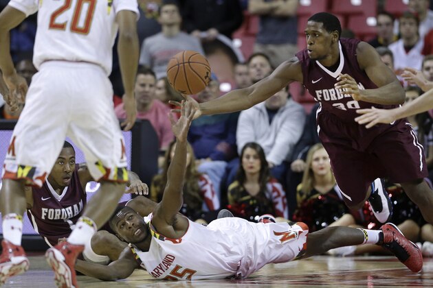Maryland forward Jon Graham, bottom, and Fordham forward Ryan Rhoomes struggle for possession of the ball as Fordham guard Mandell Thomas, back left, and Maryland guard Richaud Pack (20) watch during the first half of an NCAA college basketball game, Thursday, Nov. 20, 2014, in College Park, Md. (AP Photo/Patrick Semansky)