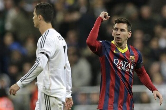 FC Barcelona's Lionel Messi from Argentina, right celebrates next to Real Madrid's Cristiano Ronaldo after scoring his team's 2nd goal during a Spanish La Liga soccer match at the Santiago Bernabeu stadium in Madrid, Sunday March 23, 2014. (AP Photo/Paul White)