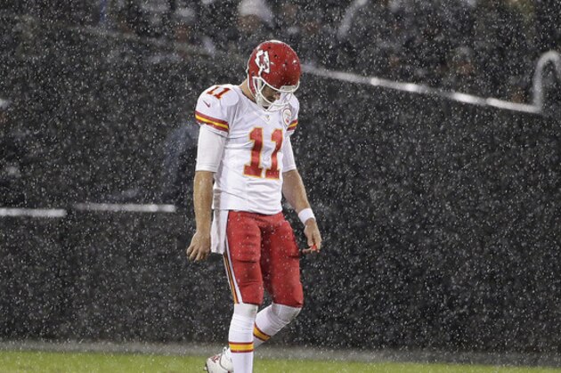Rain falls as Kansas City Chiefs quarterback Alex Smith (11) walks on the field during the second quarter of an NFL football game against the Oakland Raiders in Oakland, Calif., Thursday, Nov. 20, 2014. (AP Photo/Marcio Jose Sanchez)