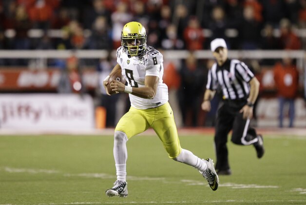 Oregon quarterback Marcus Mariota (8) carries the ball in the second half during an NCAA college football game against Utah Saturday, Nov. 8, 2014, in Salt Lake City. Oregon  won 51-27. (AP Photo/Rick Bowmer)