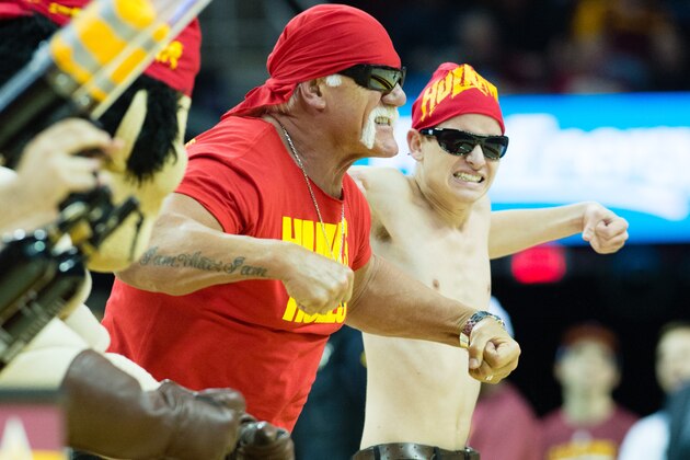 CLEVELAND, OH - NOVEMBER 19: Hulk Hogan does his signature move with a fan during the first half of the game between the Cleveland Cavaliers and the San Antonio Spurs at Quicken Loans Arena on November 19, 2014 in Cleveland, Ohio. User expressly acknowledges and agrees that, by downloading and or using this photograph, User is consenting to the terms and conditions of the Getty Images License Agreement. (Photo by Jason Miller/Getty Images)