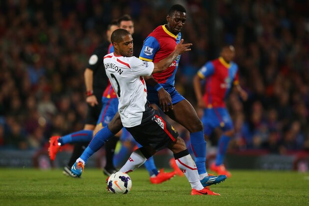 LONDON, ENGLAND - MAY 05:  Glen Johnson of Liverpool and Yannick Bolasie of Crystal Palace compete for the ball during the Barclays Premier League match between Crystal Palace and Liverpool at Selhurst Park on May 5, 2014 in London, England.  (Photo by Clive Rose/Getty Images)