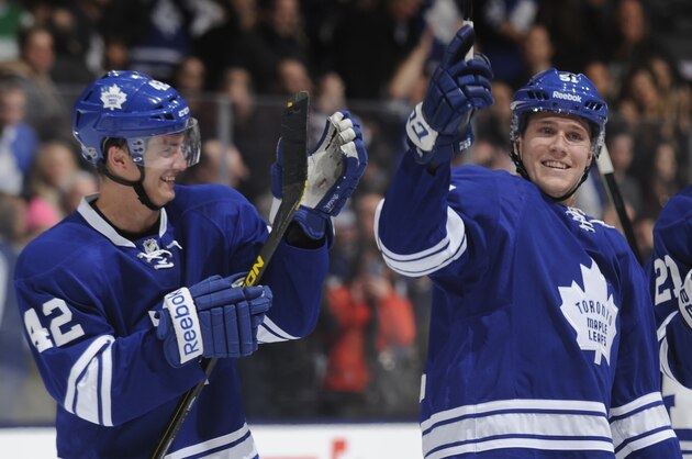 TORONTO, ON - MARCH 8:  Tyler Bozak #42 and Jake Gardiner #51 of the Toronto Maple Leafs celebrate the teams win over the Philadelphia Flyers during NHL game action March 8, 2014 at the Air Canada Centre in Toronto, Ontario, Canada. (Photo by Graig Abel/NHLI via Getty Images)