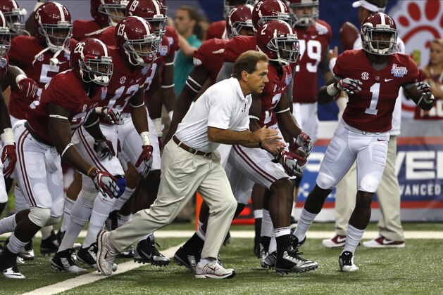 Alabama head coach Nick Saban and the Crimson Tide take the field to warm up up before an NCAA college football game against West Virginia Saturday, Aug. 30, 2014, in Atlanta.  (AP Photo/John Bazemore)