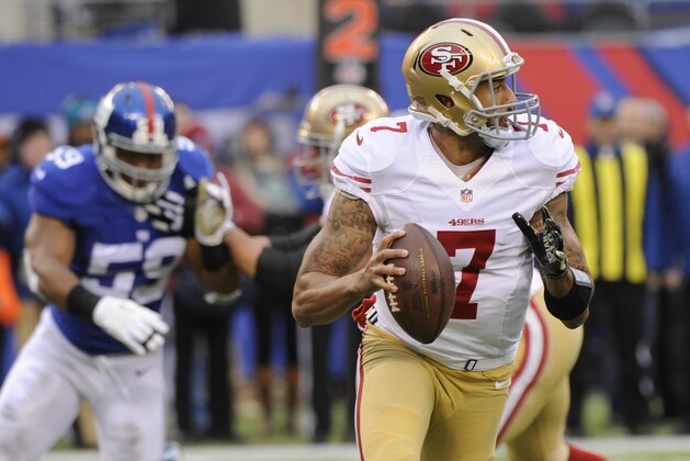 San Francisco 49ers quarterback Colin Kaepernick (7) looks to pass as New York Giants outside linebacker Devon Kennard (59) rushes him during the first half of an NFL football game Sunday, Nov. 16, 2014, in East Rutherford, N.J.  (AP Photo/Bill Kostroun)