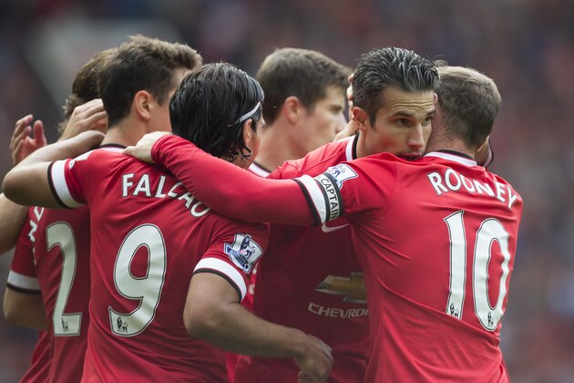 Manchester United's Robin van Persie, second right, celebrates with teammates after scoring against West Ham United during their English Premier League soccer match at Old Trafford Stadium, Manchester, England, Saturday Sept. 27, 2014. (AP Photo/Jon Super)