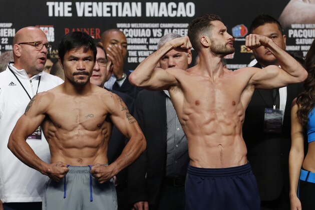 WBO welterweight champion Manny Pacquiao, left, of the Philippines and WBO junior welterweight champion Chris Algieri of the United States pose for photos during the weigh-in for their welterweight title fight at the Venetian Macao in Macau, Saturday, Nov. 22, 2014. Pacquiao and Algieri are scheduled to fight in their WBO welterweight boxing match at the casino on Nov. 23. (AP Photo/Kin Cheung)