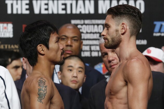 WBO welterweight champion Manny Pacquiao, left, of the Philippines, and WBO junior welterweight champion Chris Algieri of the United States look at each other during the weigh-in for their welterweight title fight at the Venetian Macao in Macau, Saturday, Nov. 22, 2014. Pacquiao and Algieri are scheduled to fight in their WBO welterweight boxing title match at the casino on Nov. 23. (AP Photo/Kin Cheung)