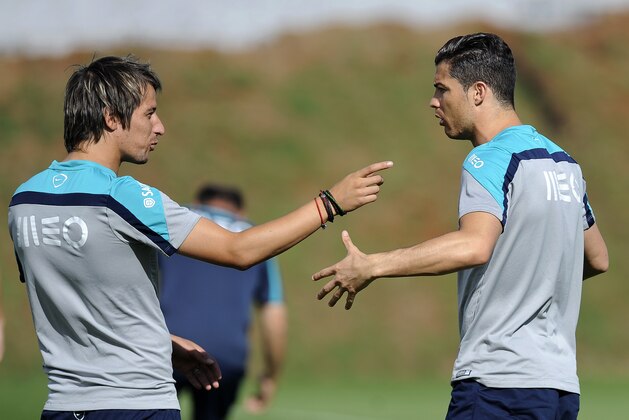 Portugal's Cristiano Ronaldo, right, talks with teammate Fabio Coentrao during a training session of Portugal in Campinas, Brazil, Saturday, June 14, 2014. Portugal plays in group G of the Brazil 2014 soccer World Cup. (AP Photo/Paulo Duarte)