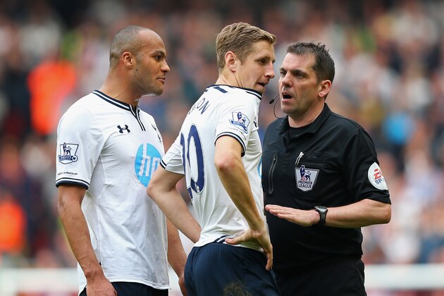 LIVERPOOL, ENGLAND - MARCH 30:  Referee Phil Dowd speaks to Younes Kaboul and Michael Dawson of Tottenham Hotspur during the Barclays Premier League match between Liverpool and Tottenham Hotspur at Anfield on March 30, 2014 in Liverpool, England.  (Photo by Alex Livesey/Getty Images)