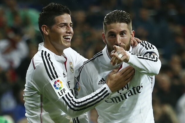 Real's Sergio Ramos, right, celebrates his goal with teammate James Rodriguez during a Spanish La Liga soccer match between Rayo Vallecano and Real Madrid at the Santiago Bernabeu stadium in Madrid, Spain, Saturday, Nov. 8, 2014. (AP Photo/Andres Kudacki)