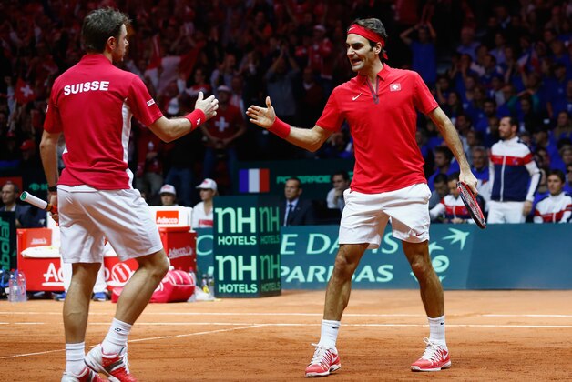 LILLE, FRANCE - NOVEMBER 22:  Roger Federer of Switzerland and Stanislas Wawrinka of Switzerland celebrate a point against Richard Gasquet of France and Julien Benneteau of France in the doubles during day two of the Davis Cup Tennis Final between France and Switzerland at the Stade Pierre Mauroy on November 22, 2014 in Lille, France.  (Photo by Julian Finney/Getty Images)