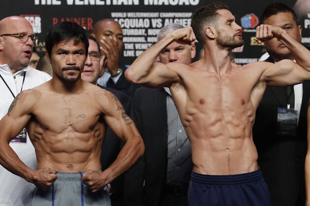 WBO welterweight champion Manny Pacquiao, left, of the Philippines and WBO junior welterweight champion Chris Algieri of the United States pose for photos during the weigh-in for their welterweight title fight at the Venetian Macao in Macau, Saturday, Nov. 22, 2014. Pacquiao and Algieri are scheduled to fight in their WBO welterweight boxing match at the casino on Nov. 23. (AP Photo/Kin Cheung)