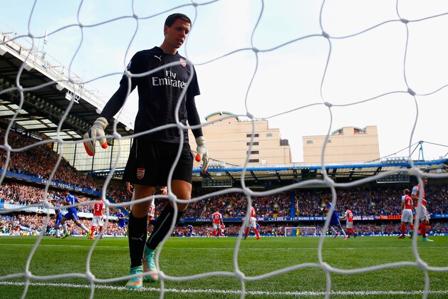 LONDON, ENGLAND - OCTOBER 05:  A dejected Wojciech Szczesny of Arsenal turns to collect the ball out of the net after Eden Hazard of Chelsea scored the first goal during the Barclays Premier League match between Chelsea and Arsenal at Stamford Bridge on October 4, 2014 in London, England.  (Photo by Paul Gilham/Getty Images)