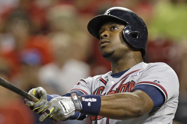 Atlanta Braves' Justin Upton hits a two-run home run off Cincinnati Reds relief pitcher Manny Parra in the 12th inning of a baseball game, Friday, Aug. 22, 2014, in Cincinnati. Atlanta won 3-1 in 12 inninngs. (AP Photo/Al Behrman)
