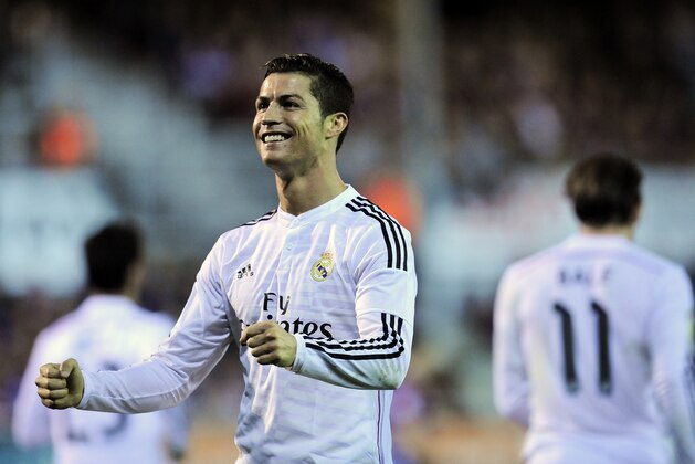 Real Madrid's Cristiano Ronaldo celebrates after scoring his goal against SD Eibar, during their La Liga soccer match, at Ipurua stadium in Eibar, northern Spain, Saturday Nov. 22, 2014. (AP Photo/Alvaro Barrientos)
