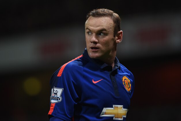 Manchester United’s Wayne Rooney walks to take a corner during the English Premier League soccer match between Arsenal and Manchester United at the Emirates Stadium, London, Saturday, Nov. 22, 2014. (AP Photo/Tim Ireland)