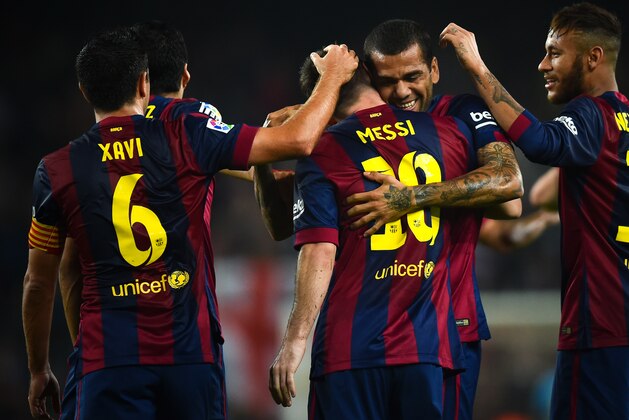 BARCELONA, SPAIN - NOVEMBER 22:  Lionel Messi (C) of FC Barcelona celebrates with his teammates after scoring the opening goal during the La Liga mach between FC Barcelona and Sevilla FC at Camp Nou on November 22, 2014 in Barcelona, Spain.  (Photo by David Ramos/Getty Images)