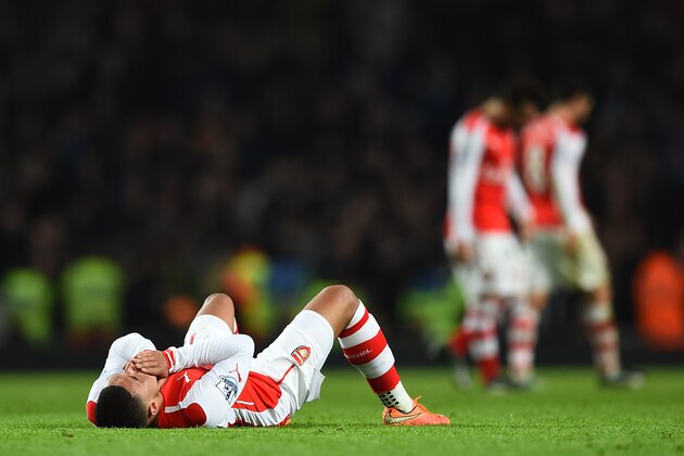 LONDON, ENGLAND - NOVEMBER 22:  Alex Oxlade-Chamberlain of Arsenal lies dejected after the Barclays Premier League match between Arsenal and Manchester United at Emirates Stadium on November 22, 2014 in London, England. (Photo by Shaun Botterill/Getty Images)