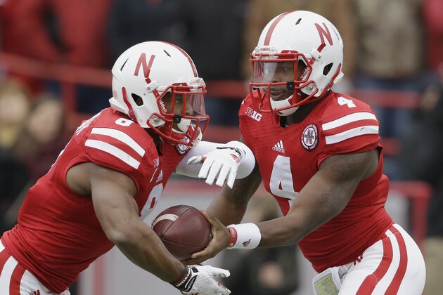 Nebraska quarterback Tommy Armstrong Jr. (4) hands off the ball to running back Ameer Abdullah (8) in the first half of an NCAA college football game against Minnesota in Lincoln, Neb., Saturday, Nov. 22, 2014. (AP Photo/Nati Harnik)