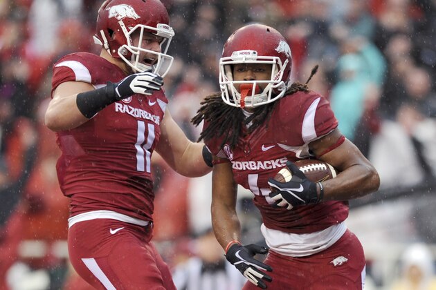 Arkansas tight end AJ Derby (11) celebrates with wide receiver Keon Hatcher (4) after Hatcher's first quarter touchdown in an NCAA college football game against Mississippi Saturday, Nov. 22, 2014, in Fayetteville, Ark. (AP Photo/Sarah Bentham)