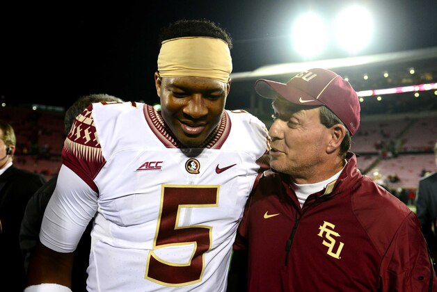Oct 30, 2014; Louisville, KY, USA;  Florida State Seminoles quarterback Jameis Winston (5) and head coach Jimbo Fisher walk off the field after defeating the Louisville Cardinals 42-31 at Papa John's Cardinal Stadium. Mandatory Credit: Andrew Weber-USA TODAY Sports
