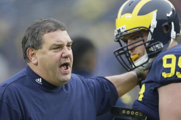 Michigan head coach Brady Hoke talks with defensive tackle Matthew Godin during warmups before the NCAA college football game against Maryland in Ann Arbor, Mich., Saturday, Nov. 22, 2014. (AP Photo/Carlos Osorio)