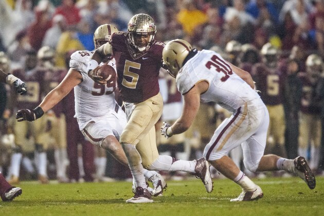 TALLAHASSEE, FL - NOVEMBER 22: Quarterback Jameis Winston #5 of the Florida State Seminoles looks for a hale in the Boston College Eagles line during the game at Doak Campbell Stadium on November 22, 2014 in Tallahassee, Florida. The Seminoles defeated the Eagles 20-17. (Photo by Jeff Gammons/Getty Images)
