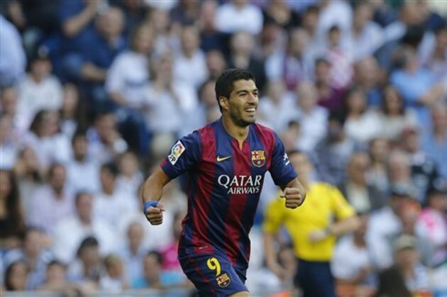 CORRECTING PLAYER WHO SCORED TO NEYMAR - Barcelona's Luis Suarez, celebrates after Barcelona teammate Neymar scored during a Spanish La Liga soccer match between Real Madrid and Barcelona at the Santiago Bernabeu stadium in Madrid, Spain, Saturday Oct. 25, 2014. (AP Photo/Paul White)