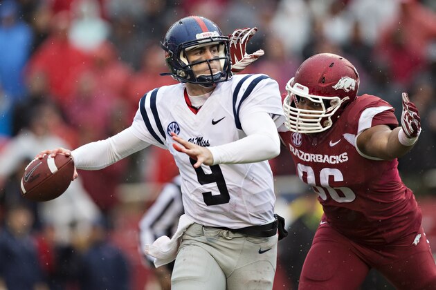 FAYETTEVILLE, AR - NOVEMBER 22:  Ryan Buchanan #9 of the Ole Miss Rebels throws a pass under pressure from Trey Flowers #86 of the Arkansas Razorbacks in the second quarter at Razorback Stadium on November 22, 2014 in Fayetteville, Arkansas.  (Photo by Wesley Hitt/Getty Images)