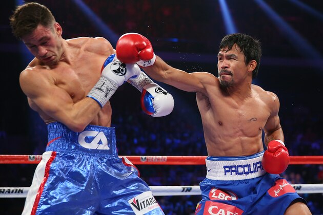 MACAU - NOVEMBER 23:  Manny Pacquiao of the Philippines and Chris Algieri of the United States exchange punches during the WBO world welterweight title at The Venetian on November 23, 2014 in Macau, Macau.