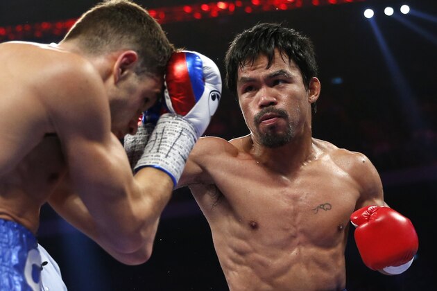 WBO welterweight champion Manny Pacquiao of the Philippines  and WBO junior welterweight champion Chris Algieri of the U.S., left, exchange punches during their world welterweight title boxing match at the Venetian Macao in Macau, Sunday, Nov. 23, 2014. Pacquiao got the big knockdowns he so desperately craved, battering Algieri around the ring at will Sunday on his way to a decision win in one of the most lopsided welterweight title fights imaginable. (AP Photo/Kin Cheung)