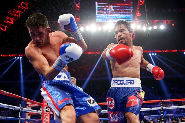MACAU - NOVEMBER 23:  Manny Pacquiao of the Philippines punches Chris Algieri of the United States during the WBO world welterweight title at The Venetian on November 23, 2014 in Macau, Macau.  (Photo by Chris Hyde/Getty Images)