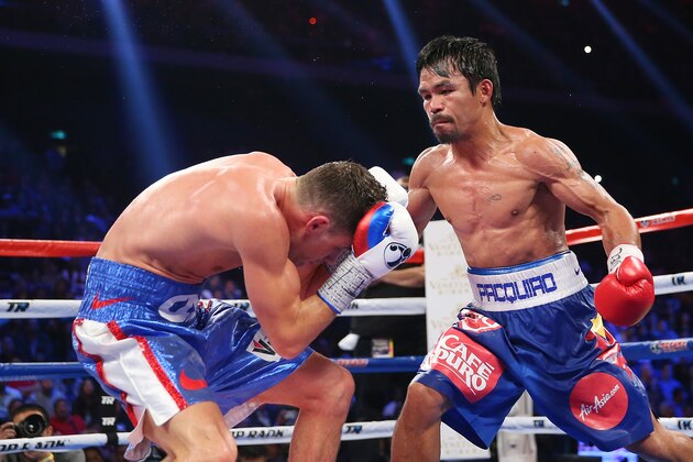 MACAU - NOVEMBER 23:  Manny Pacquiao of the Philippines punches Chris Algieri of the United States during the WBO world welterweight title at The Venetian on November 23, 2014 in Macau, Macau.  (Photo by Chris Hyde/Getty Images)